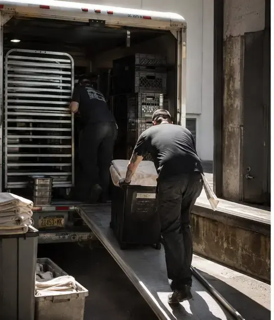 Catering team loading equipment into a van for an event